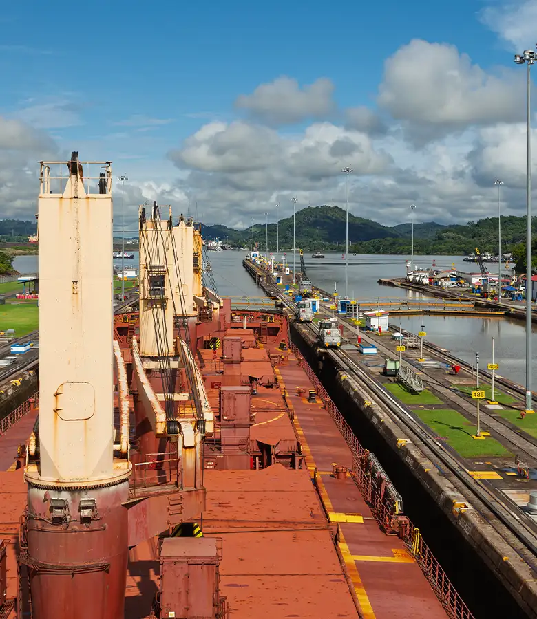 Bulk carrier vessel transiting canal representing Universal Minerals Inc technical partnerships in global iron ore shipping